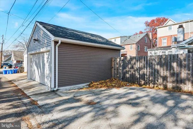 a view of a house with a wooden fence