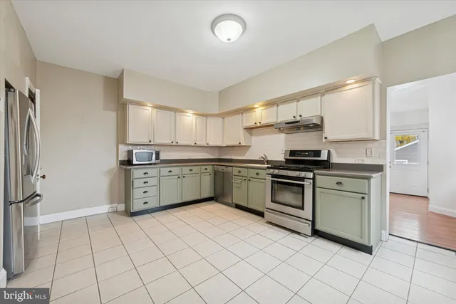 a kitchen with stainless steel appliances granite countertop a sink and cabinets