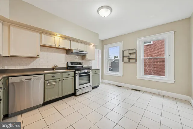 a kitchen with a sink cabinets and window