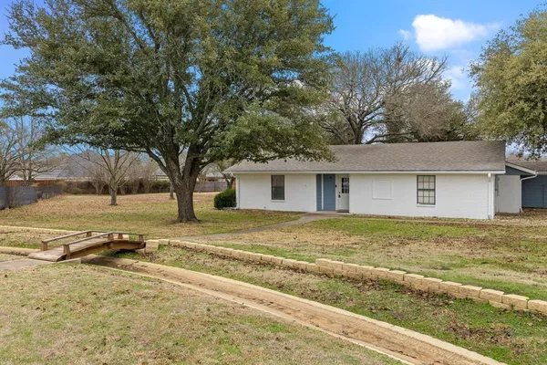 a view of a house with a yard covered with snow in a yard