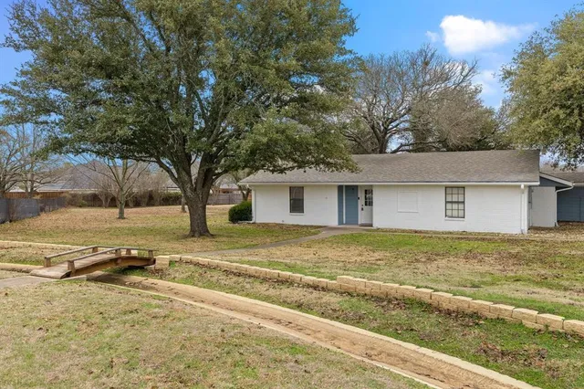 a view of a house with a yard covered with snow in a yard