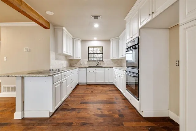 a large kitchen with stainless steel appliances a refrigerator and a sink