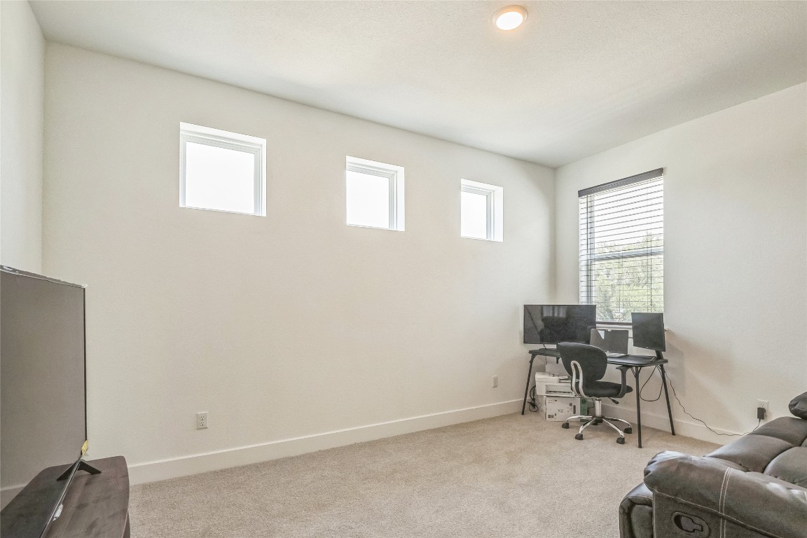 3706 Mesquite Vly Road Georgetown, TX 78628 - Photo 17 of 30 a view of a workspace with furniture and a window