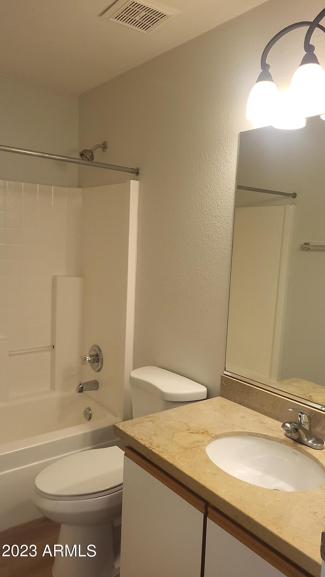 18611 North 22nd Street, Unit 9 Phoenix, AZ 85024 - Photo 15 of 18 a bathroom with a granite countertop sink toilet and shower