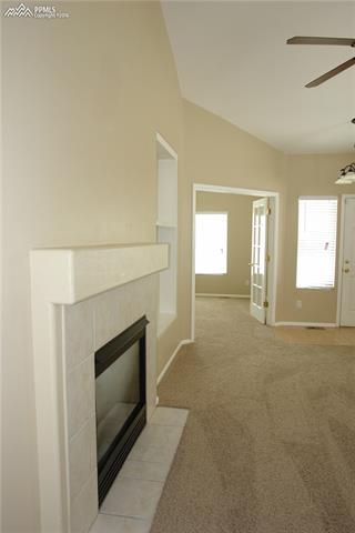 7596 Coffee Road Peyton, CO 80831 - Photo 5 of 25 Gas fireplace and mantle