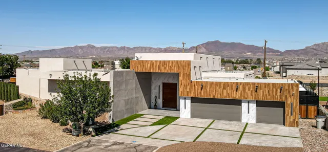 a view of a terrace with a table and chairs under an umbrella
