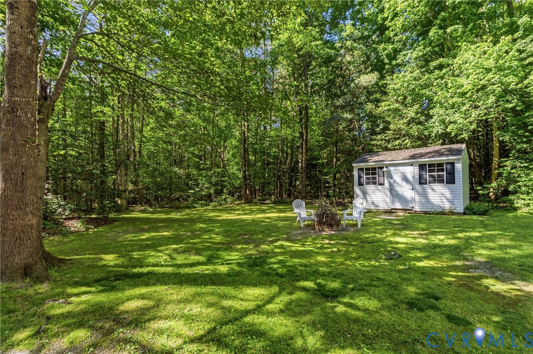 12654 Mt Olive Cohoke Road West Point, VA 23181 - Photo 27 of 31 a backyard of a house with table and chairs