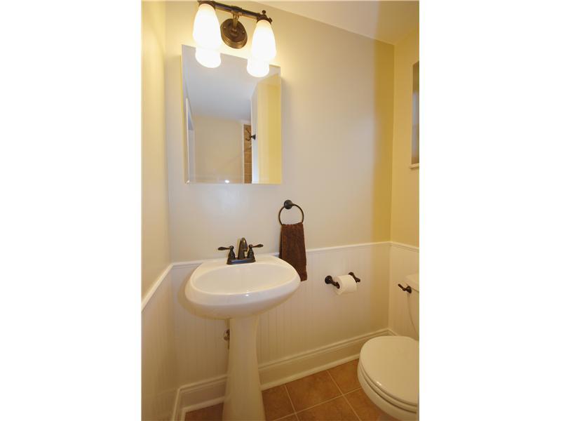 146 Orchard Spring Road Pittsburgh, PA 15220 - Photo 14 of 25 Full Bath. The full bath off the family room has been completely updated and offers wainscoting, tile floor, and pedestal sink.
