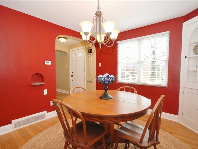 Dining Room. The dining room offers fresh wall tones with accent trim, an old-fashioned telephone rest, and built-in cabinetry. The 2-inch white blinds remain with the property.