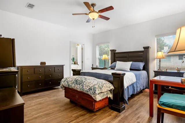 a bedroom with a bed and wooden floor