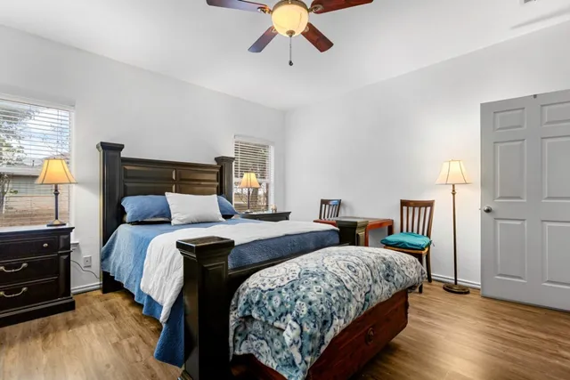 a bedroom with a bed and wooden floor