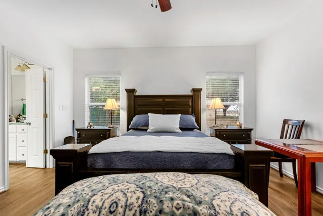 a bedroom with a bed and wooden floor