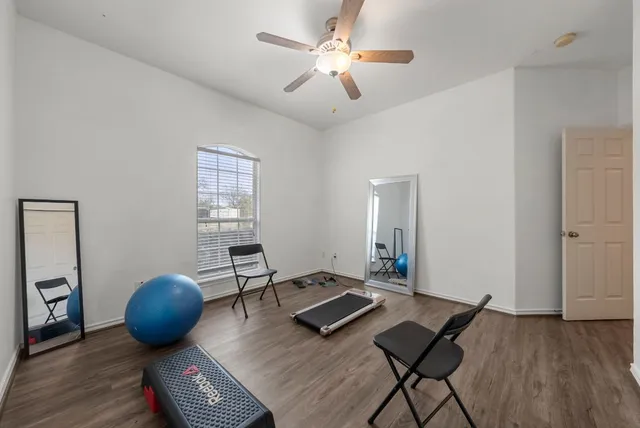 a living room with furniture and a wooden floor