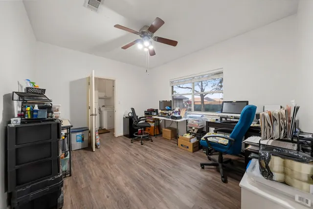 a view of a livingroom with workspace and a window