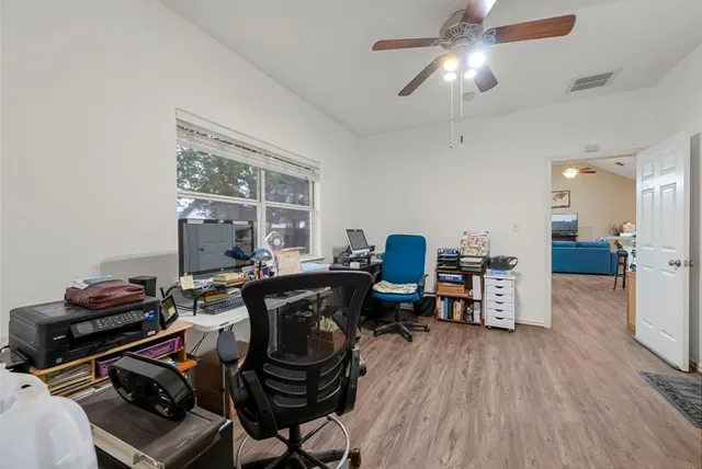 a workspace with furniture and wooden floor