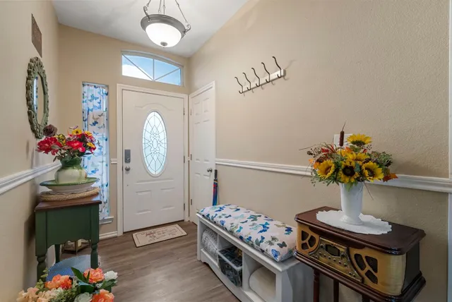 a dining room with furniture and a potted plant
