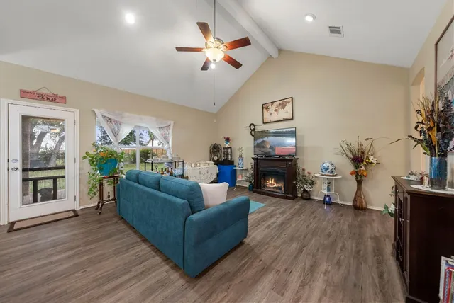 a living room with furniture a fireplace and a flat screen tv