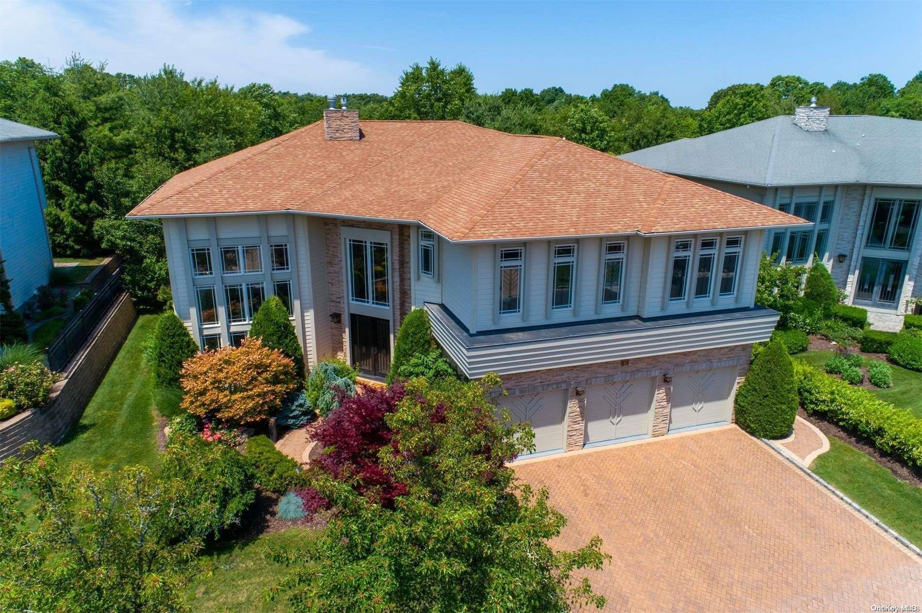 43 Kettlepond Road Jericho, NY 11753 - Photo 1 of 1 a aerial view of a house with table and chairs under an umbrella