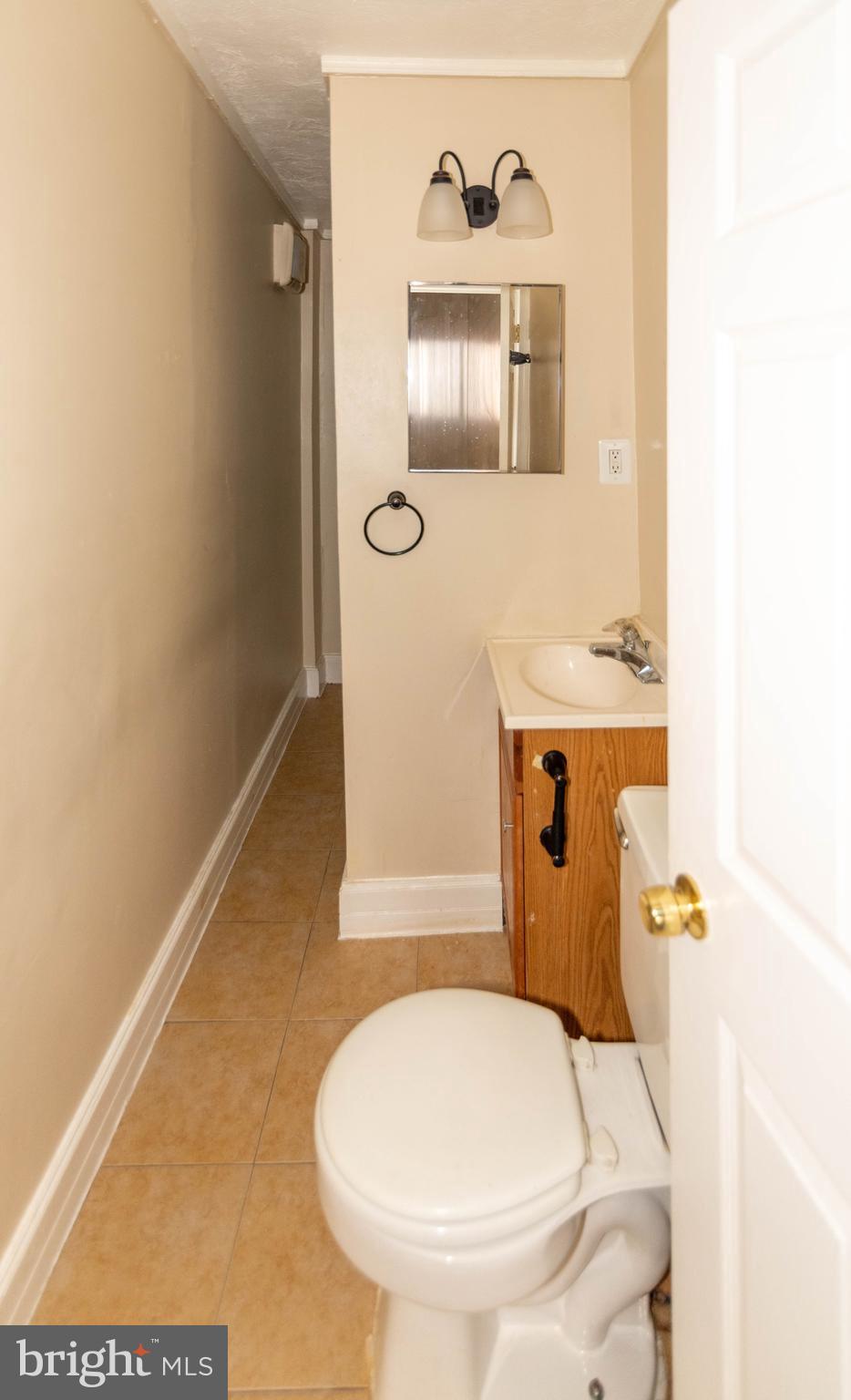 1622 Patapsco Street Baltimore, MD 21230 - Photo 21 of 30 a bathroom with a toilet and a mirror