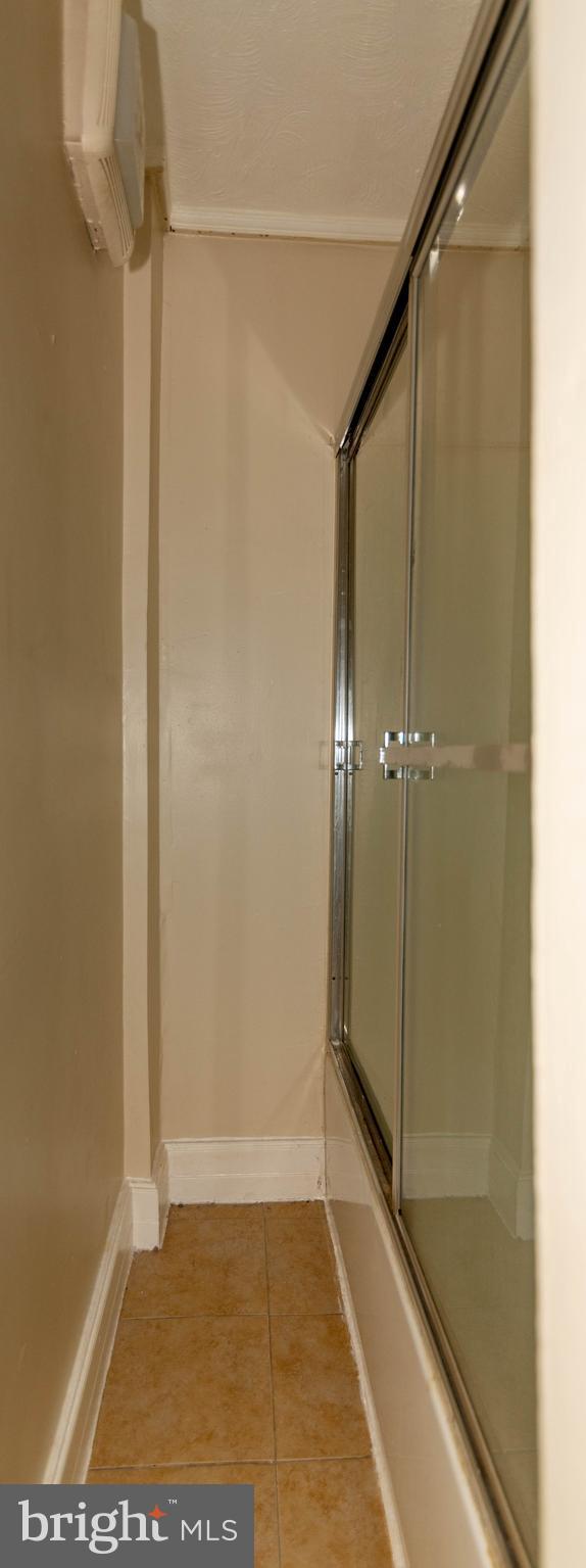1622 Patapsco Street Baltimore, MD 21230 - Photo 22 of 30 a bathroom with a shower and a glass door