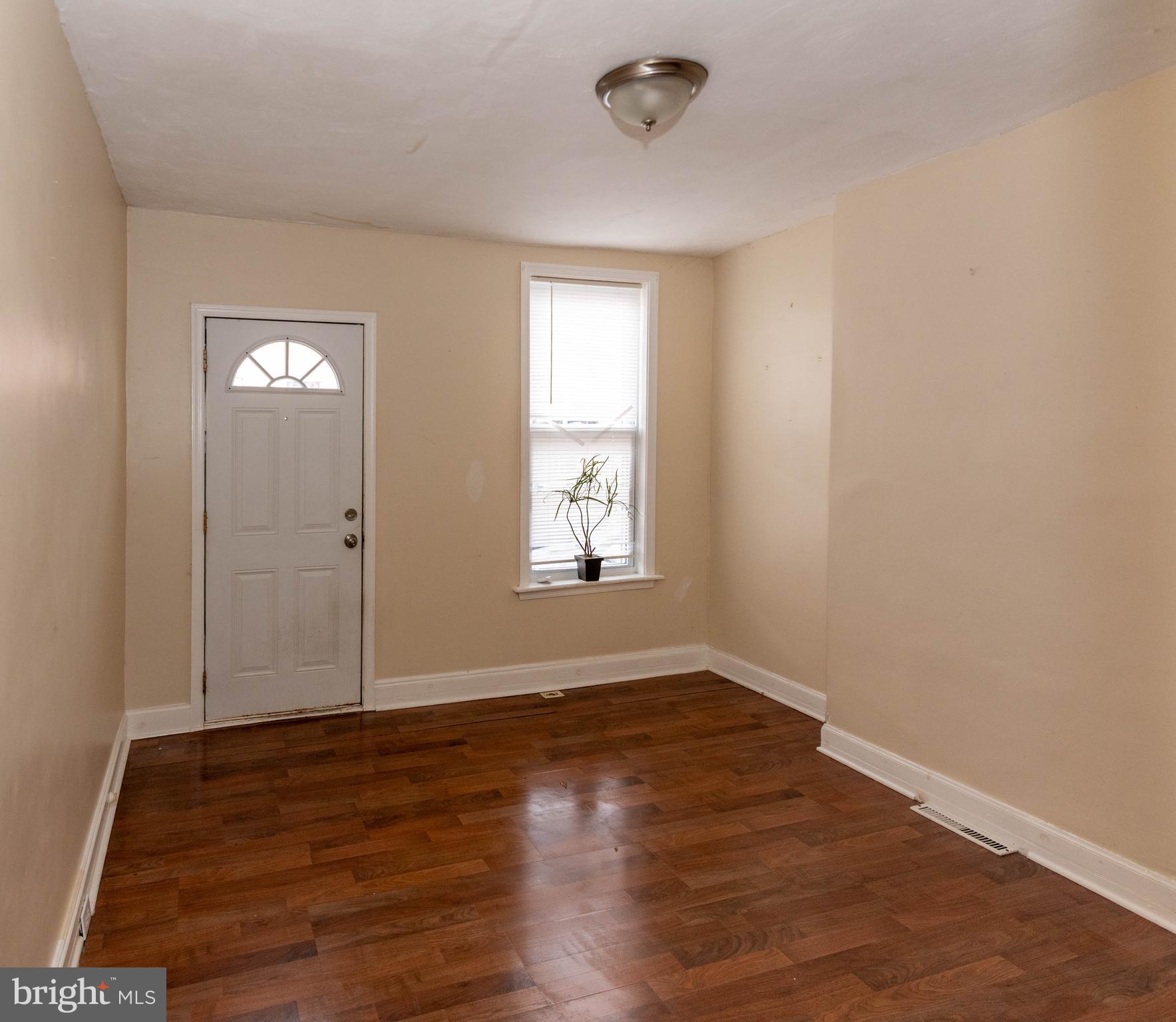 1622 Patapsco Street Baltimore, MD 21230 - Photo 5 of 30 an empty room with wooden floor and windows