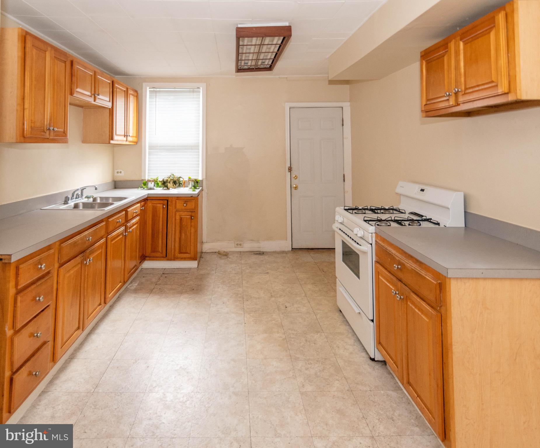 1622 Patapsco Street Baltimore, MD 21230 - Photo 8 of 30 a kitchen with stainless steel appliances granite countertop a stove a sink and a refrigerator