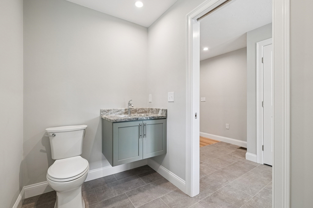 27 James Road, Unit 1 Upton, MA 01568 - Photo 12 of 41 a bathroom with a toilet sink and mirror