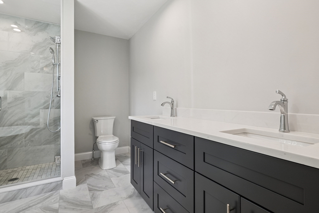 27 James Road, Unit 1 Upton, MA 01568 - Photo 18 of 41 a bathroom with a sink a toilet and shower