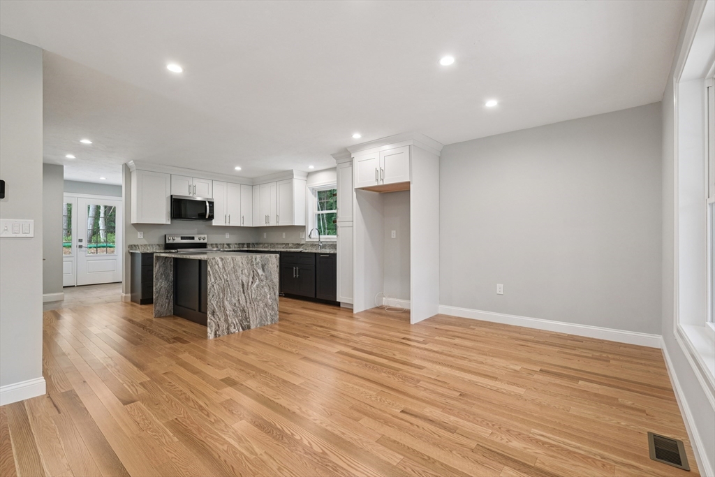 27 James Road, Unit 1 Upton, MA 01568 - Photo 5 of 41 a view of kitchen with granite countertop stainless steel appliances refrigerator and microwave