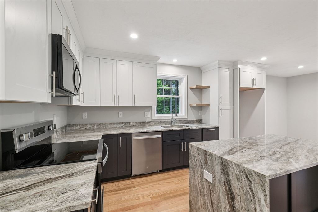 27 James Road, Unit 1 Upton, MA 01568 - Photo 6 of 41 a kitchen with stainless steel appliances granite countertop a sink stove and refrigerator