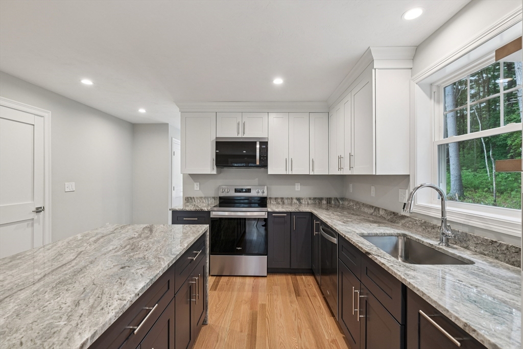 27 James Road, Unit 1 Upton, MA 01568 - Photo 7 of 41 a kitchen with a sink stove top oven and refrigerator