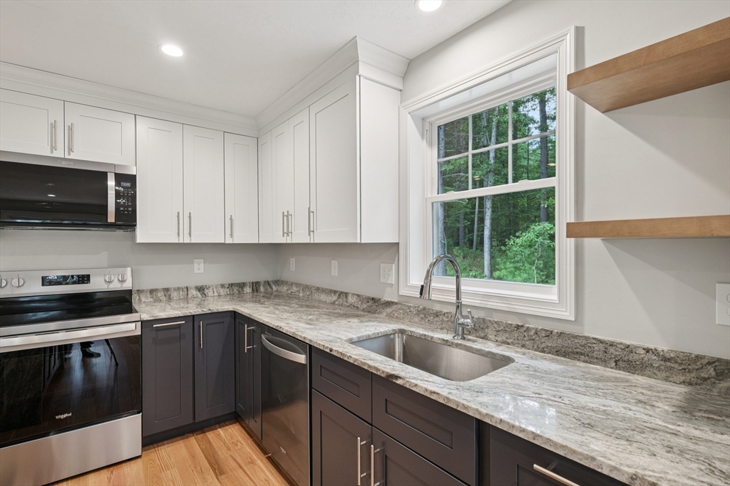 27 James Road, Unit 1 Upton, MA 01568 - Photo 8 of 41 a kitchen with granite countertop a sink a stove and cabinets