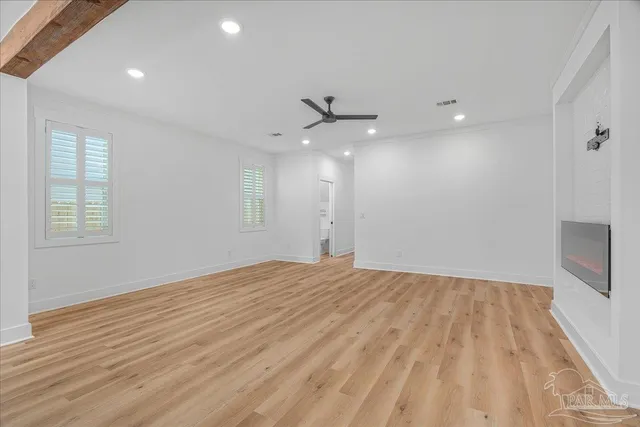 wooden floor in an empty room with a window