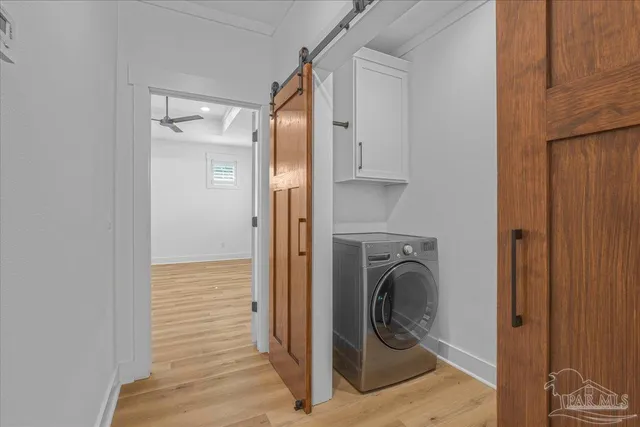a view of a hallway with washer and dryer