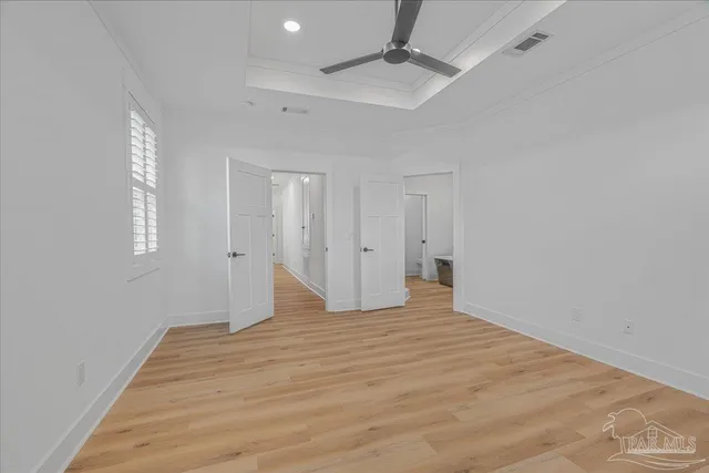 a view of empty room with wooden floor