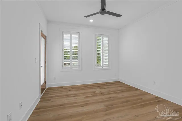 wooden floor in an empty room with a window