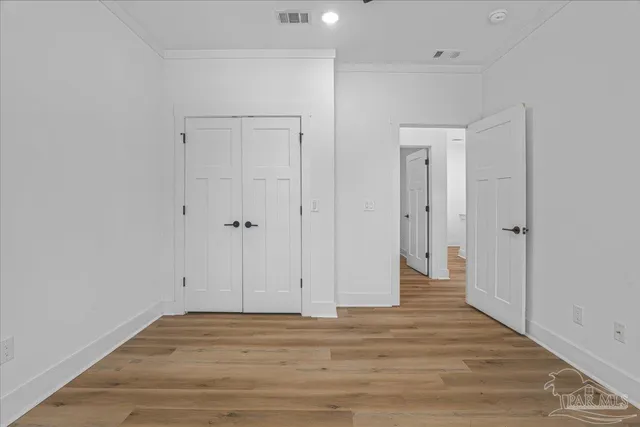 a view of room with wooden floor