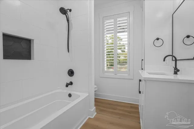 a bathroom with a tub sink and mirror