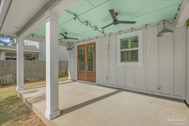a view of a porch with a table and chairs