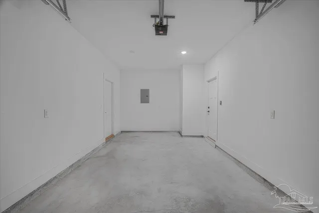 an empty room with white walls and ceiling fan