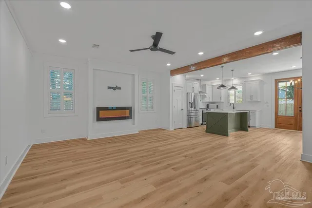 a view of an empty room with a kitchen