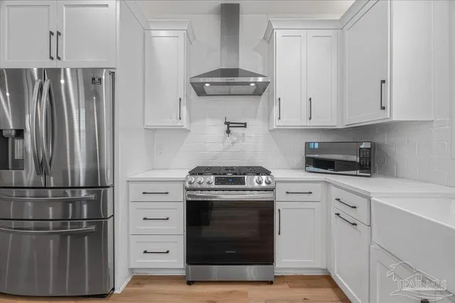 a kitchen with a stove and a refrigerator