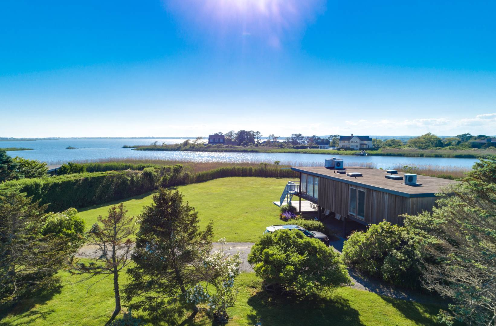 474 Jobs Lane Bridgehampton, NY 11976 - Photo 1 of 6 a view of a lake with houses in the back