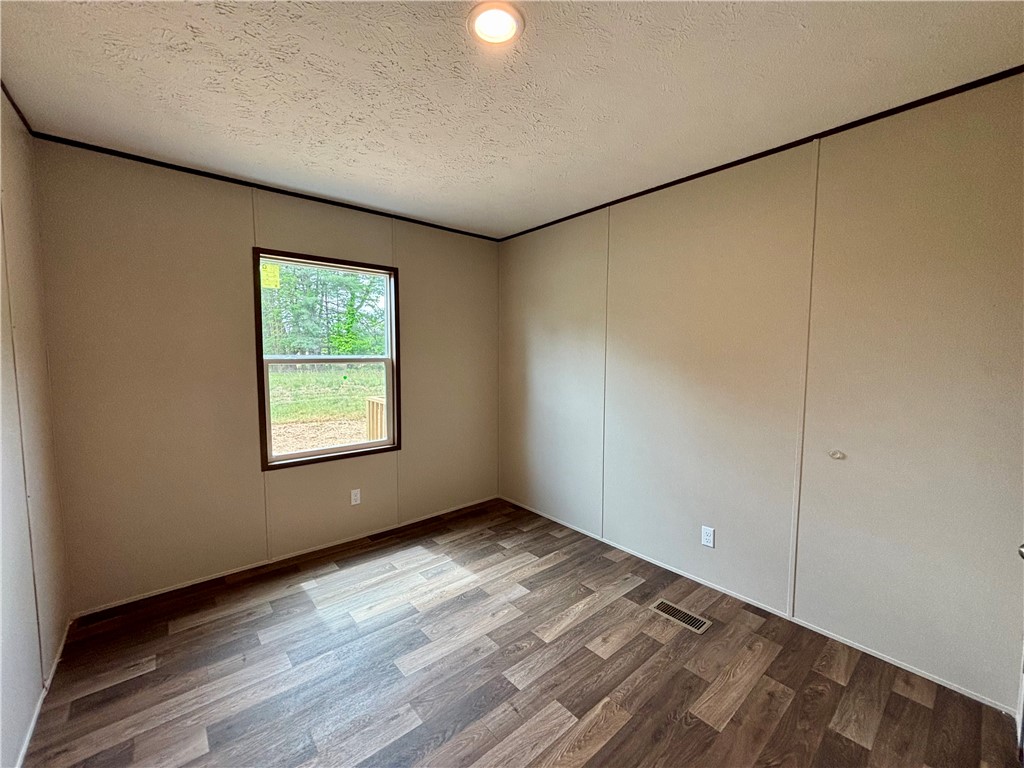 703 Double Springs Road Townville, SC 29689 - Photo 10 of 22 This spacious room offers natural light and durable flooring, ideal for a flexible living space.