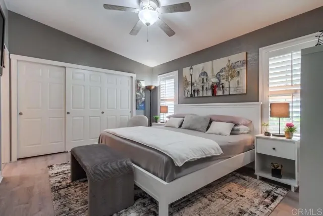 a bedroom with a large bed and a chandelier