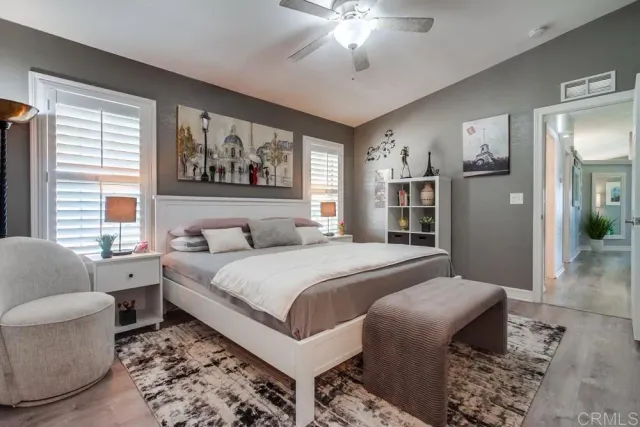 a spacious bedroom with a bed and glass windows