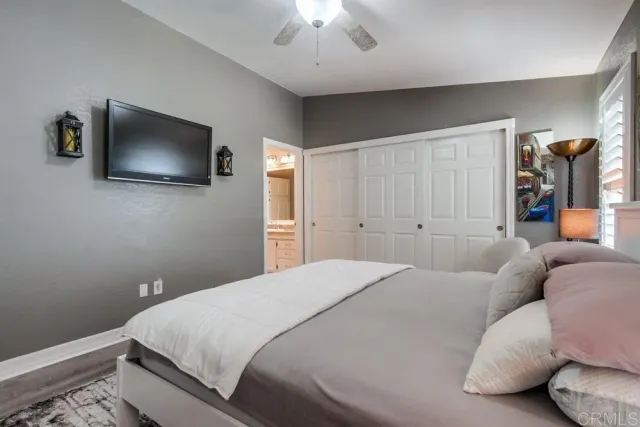 a bedroom with a bed and a flat screen tv