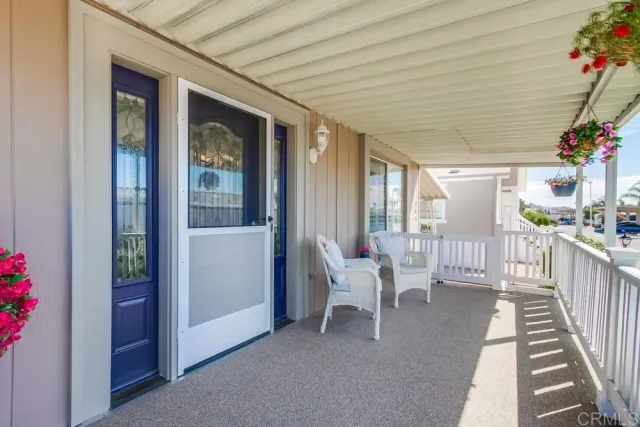a living room with furniture and a porch