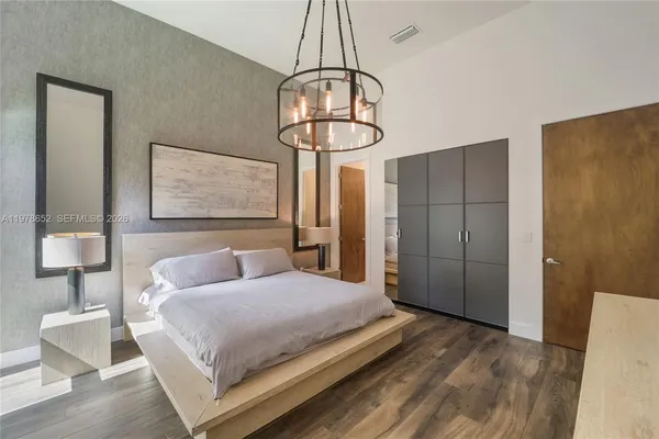 a bedroom with a bed and a mirror