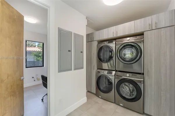 a utility room with sink dryer and washer